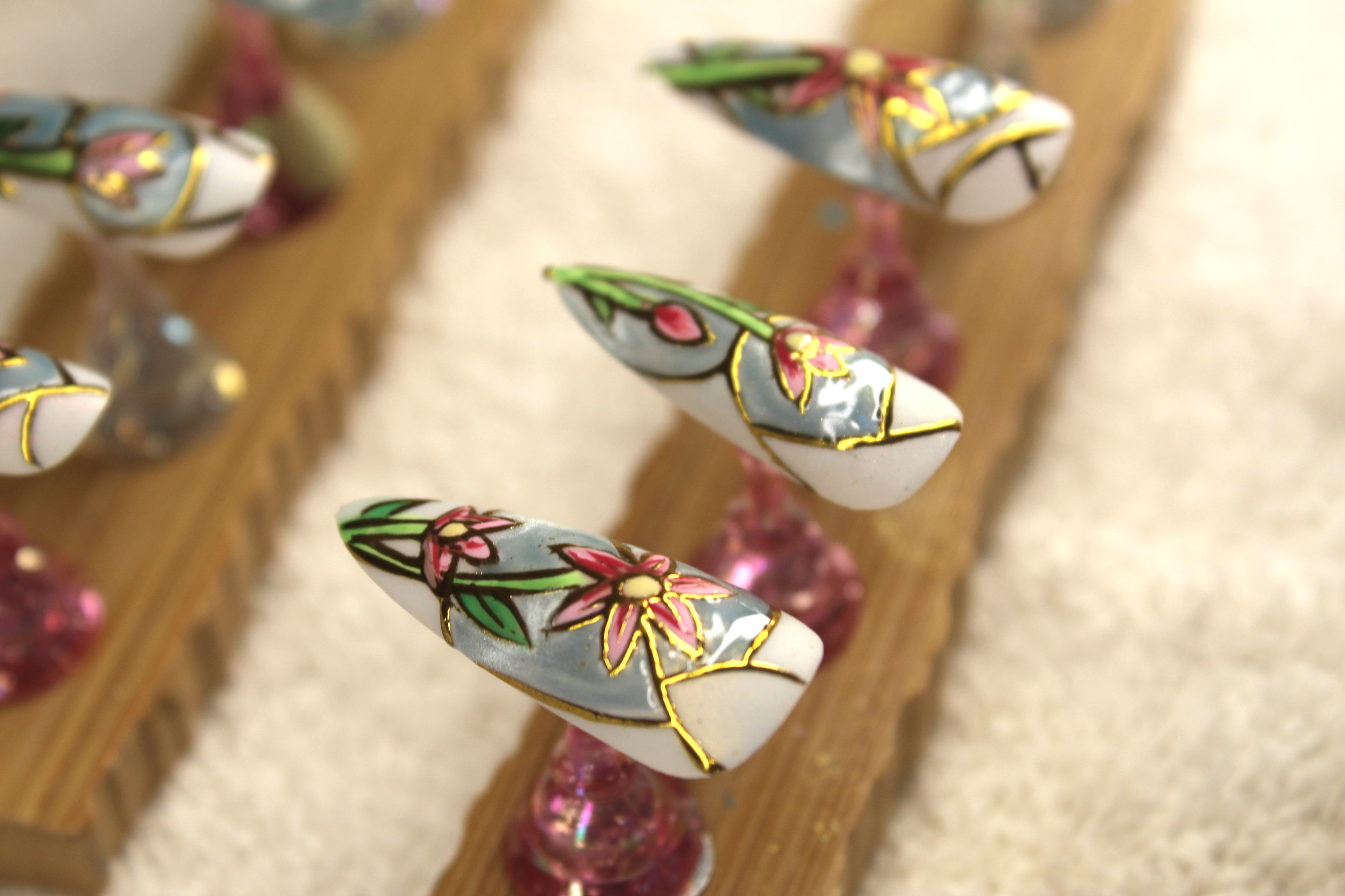 Custom nail art showcase - floral and gold detailing at Jessica Todd Salon