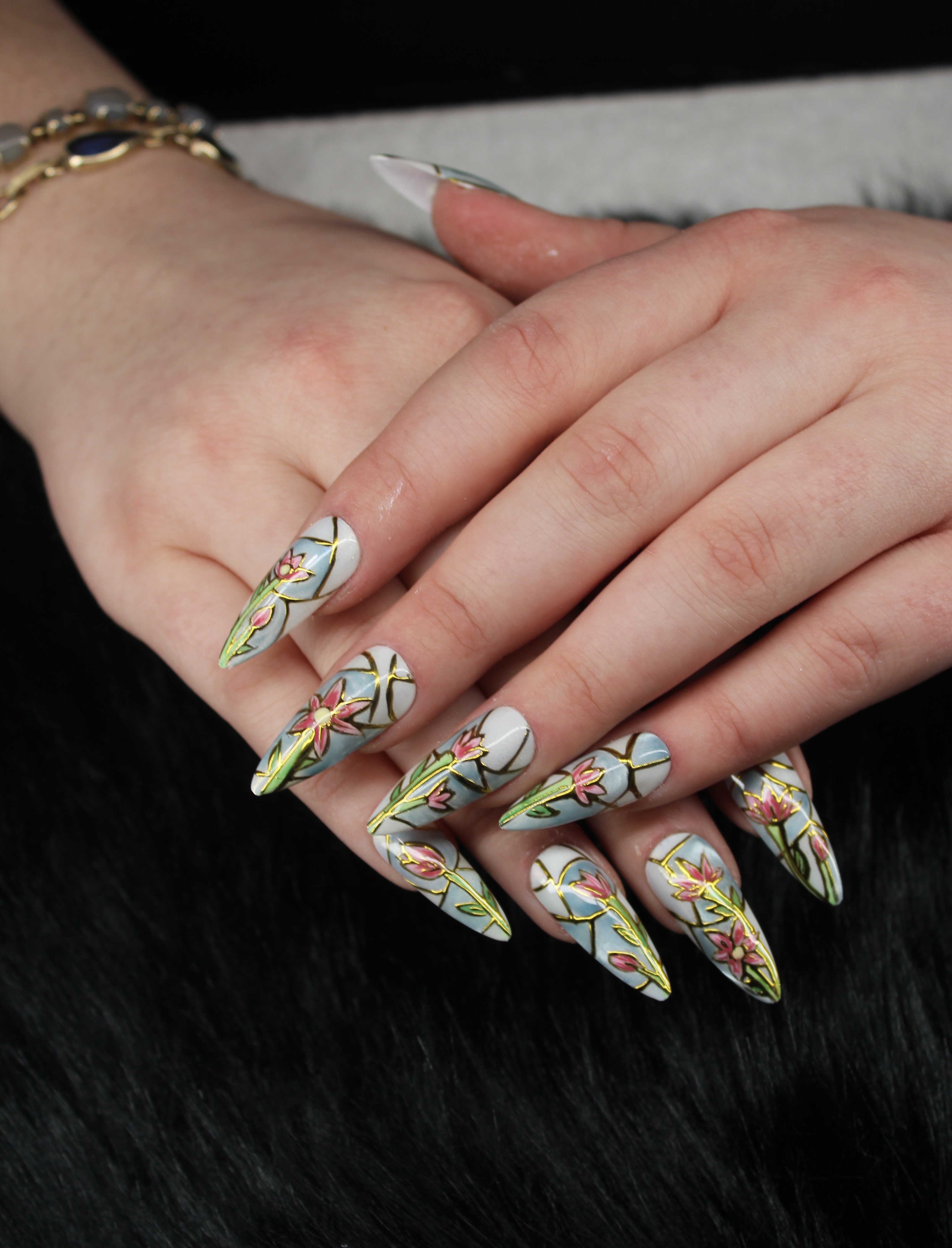 Hand-painted nail art with floral and stained-glass style design at Jessica Todd Salon