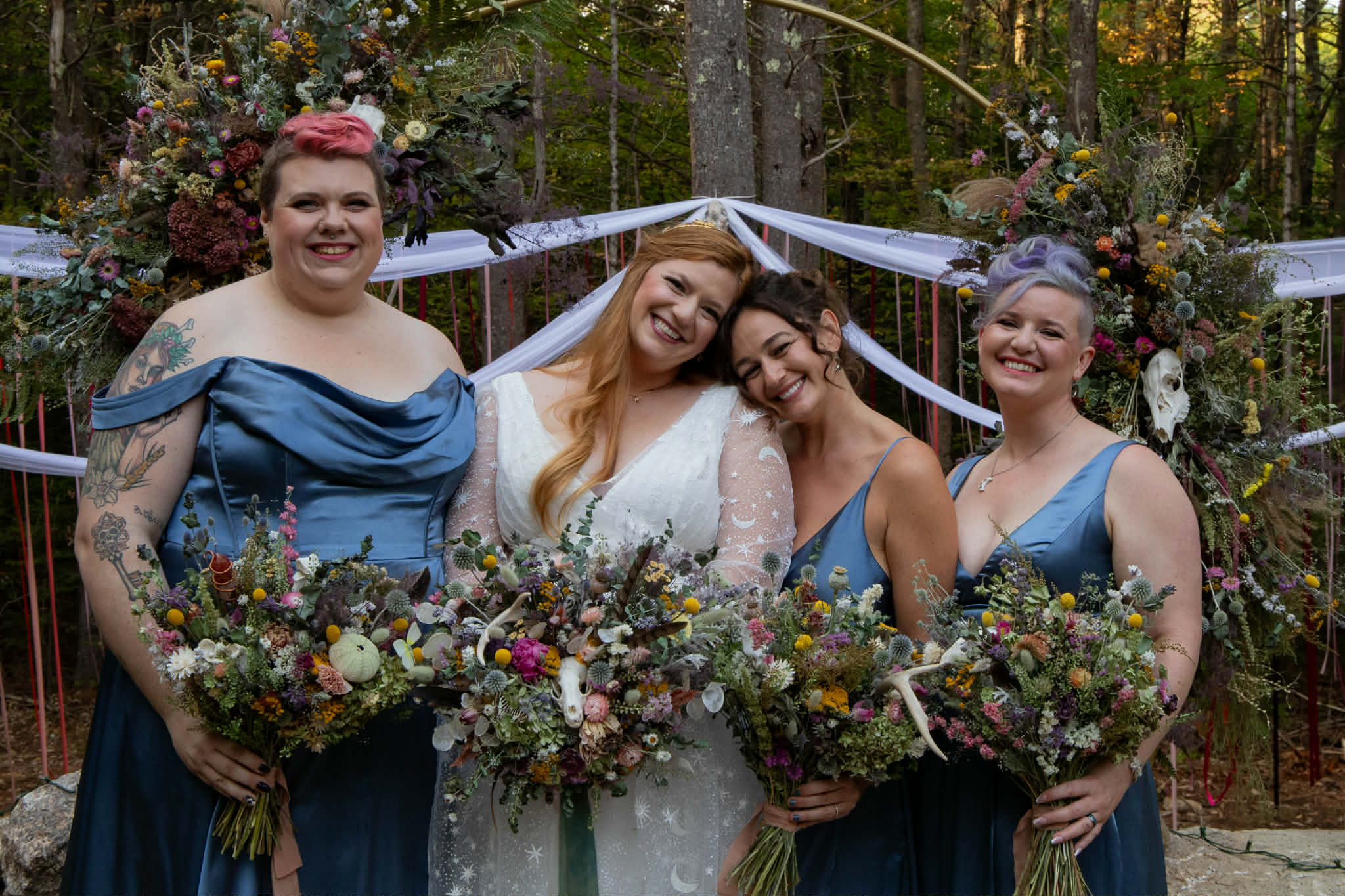 Bridal party with wedding arch